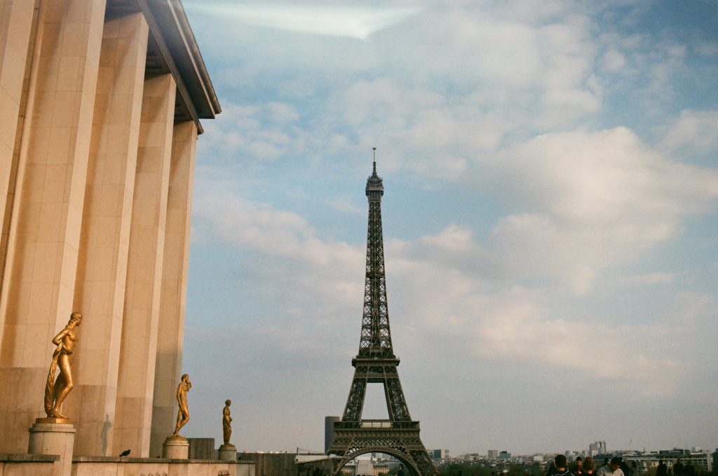 eiffel tower and old palace with statues in city